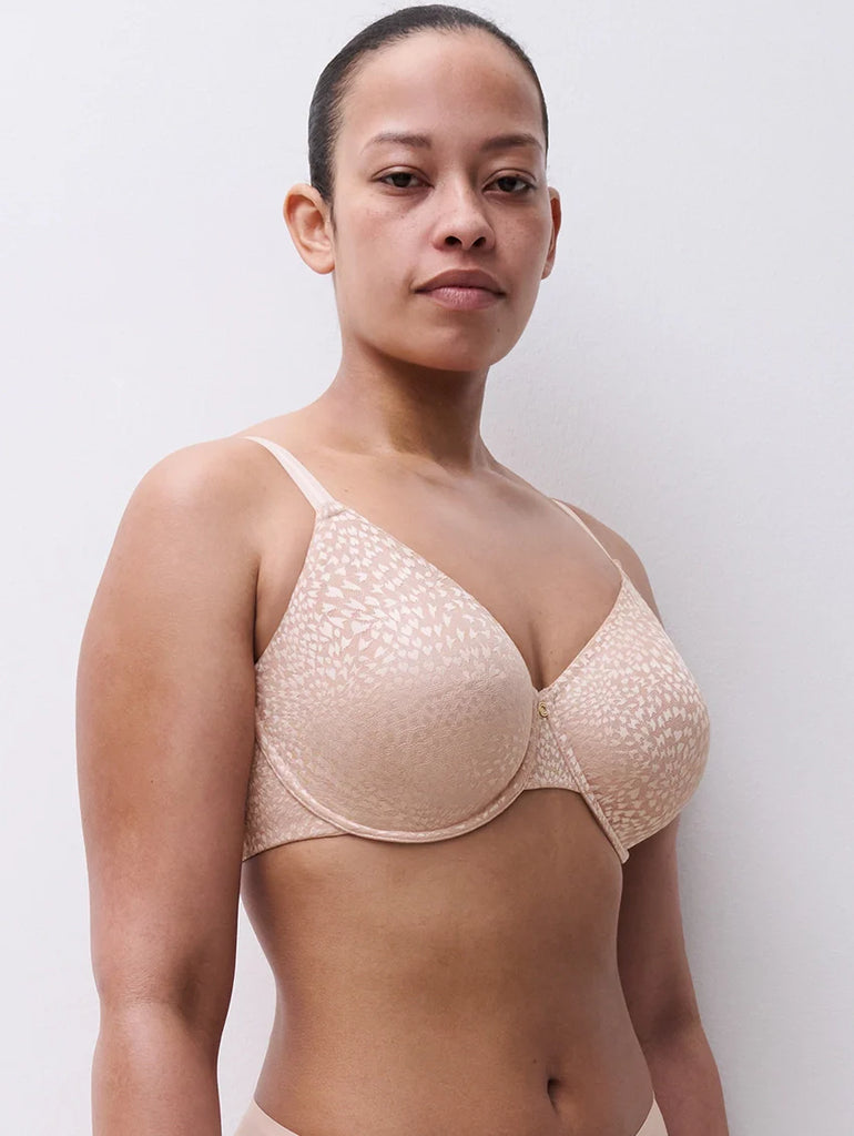 Woman wearing a soft pink bra against a plain background Chantelle Magique Seamless Bra